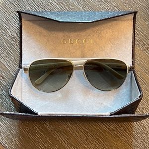 Authentic Gucci aviator style sunglasses with leather case included.